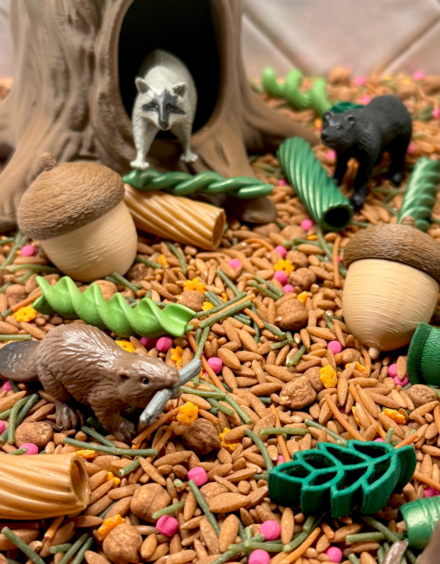 Acorn Hollow sensory play with raccoon in tree stump den, bears, beaver and acorns