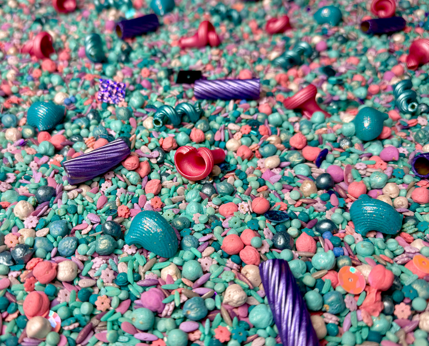 Mermaid Magic sensory mix close-up in teal, pink and purple with shell and spiral beads