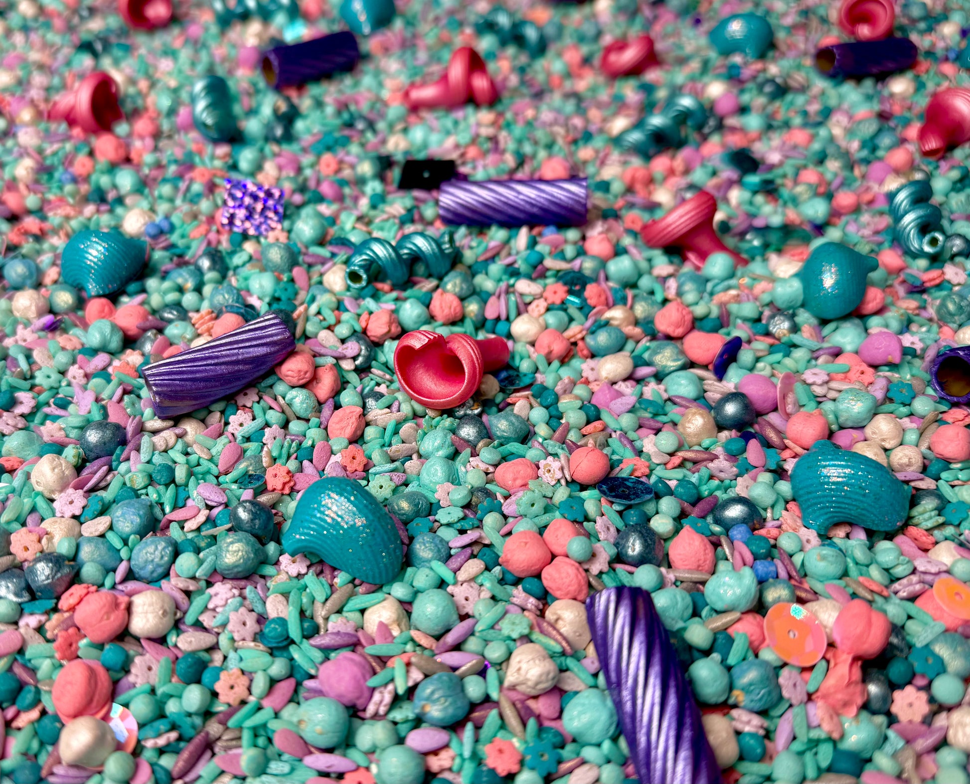 Mermaid Magic sensory mix close-up in teal, pink and purple with shell and spiral beads
