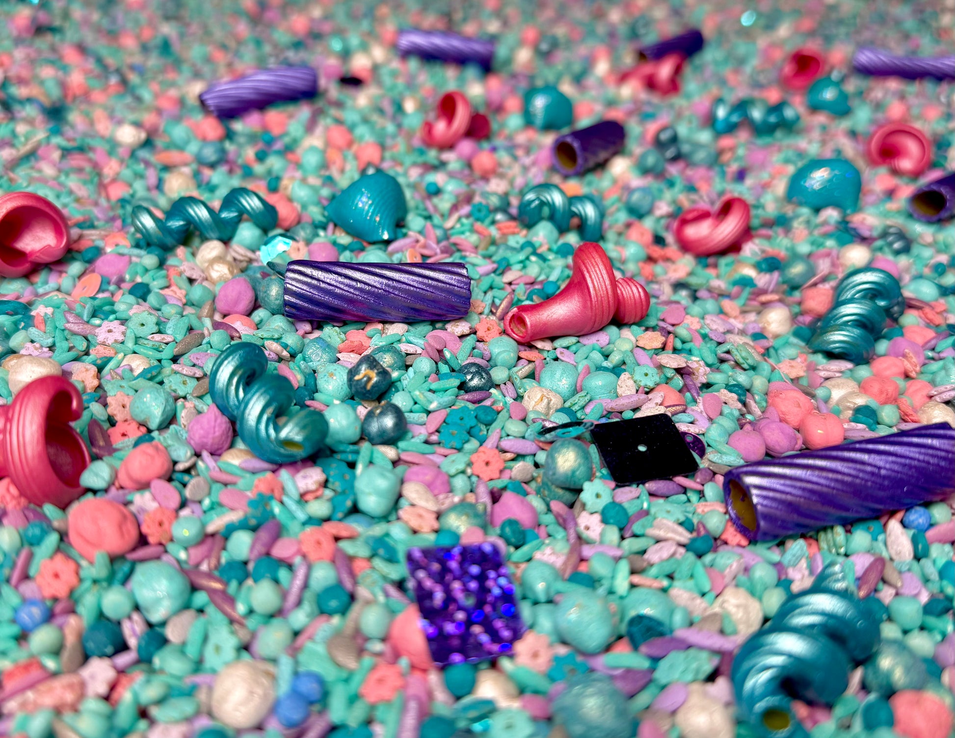 Detail of Mermaid Magic filler with purple spiral pasta, pink shells and teal beads